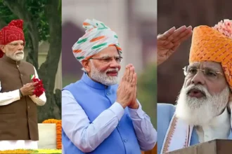# PM Modi Pagdi 2026: लाल किले पर लाल पगड़ी में दिखे पीएम मोदी, 2014 से अब तक के खास पगड़ी लुक ## PM Modi Pagdi 2026: प्रधानमंत्री नरेंद्र मोदी के स्वतंत्रता दिवस भाषण के साथ हर साल उनके पहनावे और खास तौर पर उनकी पगड़ी की भी चर्चा होती है। 2014 में प्रधानमंत्री बनने के बाद से अब तक उनके साफे और पगड़ी के रंग, डिजाइन और स्टाइल में भारत की अलग-अलग लोक परंपराओं और सांस्कृतिक विविधताओं की झलक देखने को मिली है। 2026 में भी उन्होंने लाल किले की प्राचीर से देश को संबोधित करते हुए एक खास लाल टाई-एंड-डाई साफा पहना। भारत के 80वें स्वतंत्रता दिवस के मौके पर प्रधानमंत्री नरेंद्र मोदी ने लाल किले की प्राचीर से राष्ट्र को संबोधित किया। इस दौरान उनके भाषण के साथ उनका पारंपरिक लुक भी लोगों के बीच चर्चा का विषय बना। पीएम मोदी इस बार लाल रंग के आकर्षक टाई-एंड-डाई साफे में नजर आए। उन्होंने सफेद कुर्ता-पायजामा के साथ भूरे रंग की जैकेट पहनी थी। जैकेट की जेब पर तिरंगे रंग का पॉकेट स्क्वायर उनके लुक में देशभक्ति का रंग जोड़ रहा था। प्रधानमंत्री के स्वतंत्रता दिवस के परिधान में पगड़ी या साफा पिछले कई वर्षों से एक खास पहचान बन चुका है। हर साल उनके साफे का रंग, डिजाइन और बांधने का अंदाज अलग दिखाई देता है। कई मौकों पर इनमें राजस्थान, गुजरात और देश के अन्य हिस्सों की पारंपरिक लोक कलाओं की झलक भी नजर आई है। आइए तस्वीरों के जरिए जानते हैं 2014 से 2026 तक स्वतंत्रता दिवस पर पीएम मोदी के खास पगड़ी लुक के बारे में। ## 2026: लाल टाई-एंड-डाई साफे में नजर आए पीएम मोदी 2026 के स्वतंत्रता दिवस पर प्रधानमंत्री नरेंद्र मोदी ने लाल रंग का आकर्षक टाई-एंड-डाई साफा पहना। इसमें लाल, हरे और सफेद रंगों के खूबसूरत पैटर्न दिखाई दिए। साफे का लंबा सिरा पीछे की ओर लहराता हुआ नजर आया, जिसने उनके लुक को और खास बनाया। उन्होंने सफेद कुर्ता-पायजामा के साथ भूरे रंग की जैकेट पहनी थी। जैकेट की जेब पर तिरंगे रंग का पॉकेट स्क्वायर उनके पारंपरिक पहनावे में राष्ट्रीय भावना को दर्शाता नजर आया। **(Image Source: PTI)** ## 2025: गहरे भगवा रंग की शाही पगड़ी 2025 के स्वतंत्रता दिवस समारोह में पीएम मोदी गहरे भगवा रंग की पगड़ी में नजर आए। पगड़ी का रंग काफी प्रभावशाली था और इसमें तिरंगे रंगों का संयोजन भी देखने को मिला। भगवा साफे के साथ पारंपरिक पोशाक ने उनके लुक को अलग पहचान दी। स्वतंत्रता दिवस समारोह के दौरान पीएम मोदी की यह पगड़ी भी आकर्षण का केंद्र रही। **(Image Source: PTI)** ## 2024: भगवा-हरे रंग की पगड़ी 2024 में प्रधानमंत्री नरेंद्र मोदी ने भगवा और हरे रंग के संयोजन वाली पगड़ी पहनी थी। इसके साथ उन्होंने नीले रंग की सदरी पहनी, जिससे पगड़ी के रंग और अधिक उभरकर दिखाई दे रहे थे। उनका यह पारंपरिक अंदाज स्वतंत्रता दिवस के मौके पर खूब चर्चा में रहा। पगड़ी के रंगों का संयोजन पीएम मोदी के पिछले कई स्वतंत्रता दिवस लुक से अलग नजर आया। ## 2023: बहुरंगी राजस्थानी बांधनी पगड़ी 2023 में पीएम मोदी ने बहुरंगी राजस्थानी बांधनी प्रिंट वाली पगड़ी पहनी। इसमें लाल, पीले, हरे और बैंगनी जैसे चटख रंगों का इस्तेमाल दिखाई दिया। इसके साथ उन्होंने काले रंग की जैकेट पहनी थी। रंग-बिरंगी पगड़ी में राजस्थान की लोक कला और सांस्कृतिक विरासत की झलक नजर आई। पीएम मोदी का यह साफा उनके स्वतंत्रता दिवस के सबसे रंगीन लुक में से एक रहा। **(Image Source: PTI)** ## 2022: तिरंगे रंगों वाली पगड़ी आजादी का अमृत महोत्सव और हर घर तिरंगा अभियान के दौर में 2022 का स्वतंत्रता दिवस बेहद खास था। इस मौके पर पीएम मोदी की पगड़ी भी देशभक्ति के रंग में नजर आई। उन्होंने तिरंगे रंगों वाली पगड़ी पहनी और इसके साथ नीले रंग की जैकेट का चुनाव किया। पगड़ी को बांधने का अलग अंदाज भी लोगों के बीच चर्चा में रहा। **(Image Source: PTI)** ## 2021: केसरी और लाल रंगों का खास पैटर्न देश के 75वें स्वतंत्रता दिवस पर प्रधानमंत्री मोदी ने केसरी और लाल रंगों के पैटर्न वाली पगड़ी पहनी। इसके साथ उन्होंने हल्के नीले रंग की जैकेट पहनी थी। पगड़ी का डिजाइन और उसका लंबा ट्रेल उनके पूरे लुक को खास बना रहा था। इसमें पश्चिमी भारत की पारंपरिक शैली की झलक दिखाई दी। **(Image Source: PTI)** ## 2020: कोरोना काल में सादगी भरा लुक 2020 का स्वतंत्रता दिवस कोरोना महामारी के बीच मनाया गया था। उस समय पीएम मोदी का लुक सादगी और संदेश दोनों के लिहाज से खास रहा। उन्होंने केसरिया रंग की पगड़ी पहनी, जिस पर क्रीम रंग का प्रिंट दिखाई दे रहा था। इसके साथ क्रीम रंग की जैकेट पहनी गई थी। महामारी के दौर में उनके गमछे ने भी लोगों का ध्यान खींचा। **(Image Source: PTI)** ## 2019: बहुरंगी राजस्थानी पगड़ी 2019 में लगातार दूसरी बार प्रधानमंत्री बनने के बाद लाल किले से स्वतंत्रता दिवस संबोधन के दौरान नरेंद्र मोदी ने बहुरंगी राजस्थानी पगड़ी पहनी। इसमें लाल, पीले और हरे रंगों के साथ खूबसूरत कढ़ाई और डिजाइन नजर आए। रंगीन साफे ने उनके पारंपरिक अंदाज को और आकर्षक बनाया। **(Image Source: PTI)** ## 2018: भगवा पगड़ी ने खींचा ध्यान 2018 के स्वतंत्रता दिवस पर पीएम मोदी भगवा रंग की पगड़ी में नजर आए। पगड़ी का रंग और पारंपरिक शैली उनके पहनावे की खास पहचान बनी। भगवा रंग भारतीय परंपरा और सांस्कृतिक प्रतीकों में खास महत्व रखता है। पीएम मोदी के इस लुक ने स्वतंत्रता दिवस समारोह में उनकी पारंपरिक शैली को अलग पहचान दी। **(Image Source: PTI)** ## 2017: लाल पगड़ी और क्रीम जैकेट का कॉम्बिनेशन 2017 में प्रधानमंत्री नरेंद्र मोदी ने लाल रंग की आकर्षक पगड़ी पहनी थी। इसके साथ उन्होंने क्रीम रंग की जैकेट पहनी। लाल पगड़ी और हल्के रंग की जैकेट का कॉम्बिनेशन काफी प्रभावशाली नजर आया। इस साल का साफा भी उनके पारंपरिक स्वतंत्रता दिवस लुक में खास रहा। ## 2016: गुलाबी-पीली बांधनी शैली 2016 में पीएम मोदी ने गुलाबी और पीले रंगों वाली टाई-एंड-डाई यानी बांधनी शैली की पगड़ी पहनी। इसमें कई रंगों का सुंदर मिश्रण और पारंपरिक डिजाइन दिखाई दिया। राजस्थान की लोक कला से प्रेरित यह साफा उस साल स्वतंत्रता दिवस समारोह के प्रमुख आकर्षणों में शामिल रहा। **(Image Source: PTI)** ## 2015: क्रिस-क्रॉस डिजाइन वाली राजस्थानी पगड़ी 2015 के स्वतंत्रता दिवस पर प्रधानमंत्री ने क्रिस-क्रॉस डिजाइन वाली राजस्थानी शैली की पगड़ी चुनी। इसमें पीले रंग के साथ लाल और गहरे हरे रंग की धारियां दिखाई देती थीं। उन्होंने खादी सिल्क कुर्ते के साथ नेहरू जैकेट पहनी थी। रंगीन पगड़ी के साथ उनका यह पारंपरिक पहनावा काफी आकर्षक नजर आया। **(Image Source: PTI)** ## 2014: प्रधानमंत्री के रूप में पहला पगड़ी लुक 2014 में प्रधानमंत्री नरेंद्र मोदी ने अपने पहले स्वतंत्रता दिवस समारोह में पारंपरिक राजस्थानी बंधेज पगड़ी पहनी थी। यह लाल और हरे रंग के आकर्षक संयोजन वाली पगड़ी थी। इसका लंबा सिरा पीछे की ओर लटक रहा था और पगड़ी ने उनके पहले स्वतंत्रता दिवस लुक को खास पहचान दी। 2014 के इसी अंदाज के बाद स्वतंत्रता दिवस पर पीएम मोदी की पगड़ी हर साल लोगों की नजरों में रहने लगी। ## हर साल अलग पगड़ी, दिखती है भारत की सांस्कृतिक विविधता 2014 से 2026 तक प्रधानमंत्री नरेंद्र मोदी के स्वतंत्रता दिवस के पगड़ी लुक पर नजर डालें तो इसमें रंगों और डिजाइनों की काफी विविधता दिखाई देती है। कहीं राजस्थानी बांधनी और बंधेज की झलक मिलती है तो कहीं तिरंगे रंगों का इस्तेमाल नजर आता है। यही वजह है कि स्वतंत्रता दिवस पर पीएम मोदी का पहनावा उनके भाषण के साथ सोशल मीडिया और खबरों में भी चर्चा का विषय बन जाता है। 2026 में लाल टाई-एंड-डाई साफे के साथ उनका लुक भी इसी परंपरा का हिस्सा रहा। pm-modi-pagdi-2026-2014-se-2026-tak-pagdi-look