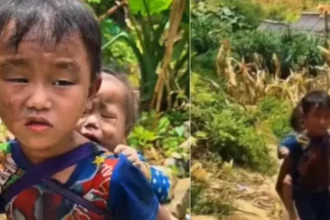 nepal-floods-little-boy-carries-sister-searching-missing-parents